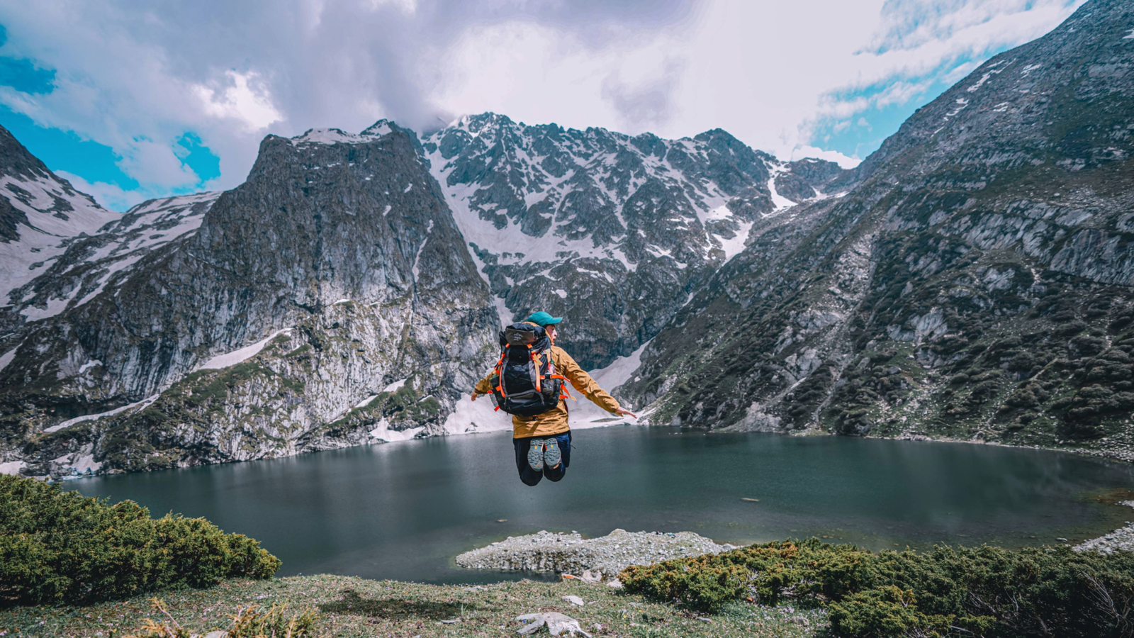Trekkers beside an alpine lake on the Kashmir Great Lakes Trek